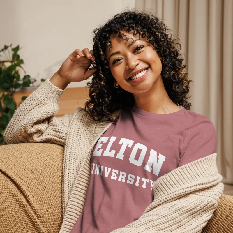 Smiling woman in a rose Elton University t-shirt and knit cardigan